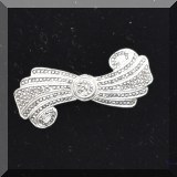 J085. Sterling silver rolled bow shaped pin. Missing one facet. 2”w - $22 